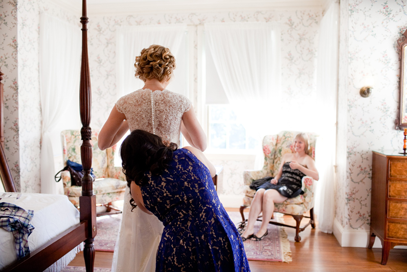 bride getting into dress at the lyman estate - boston wedding