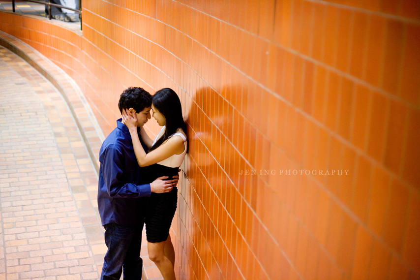 Harvard engagement session in Cambridge, MA - couple against orange wall in the Garage