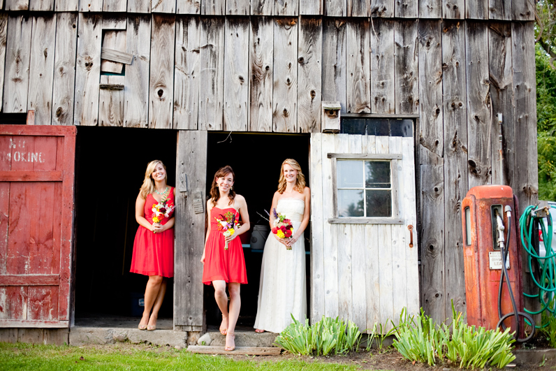 bride and bridesmaid in barn