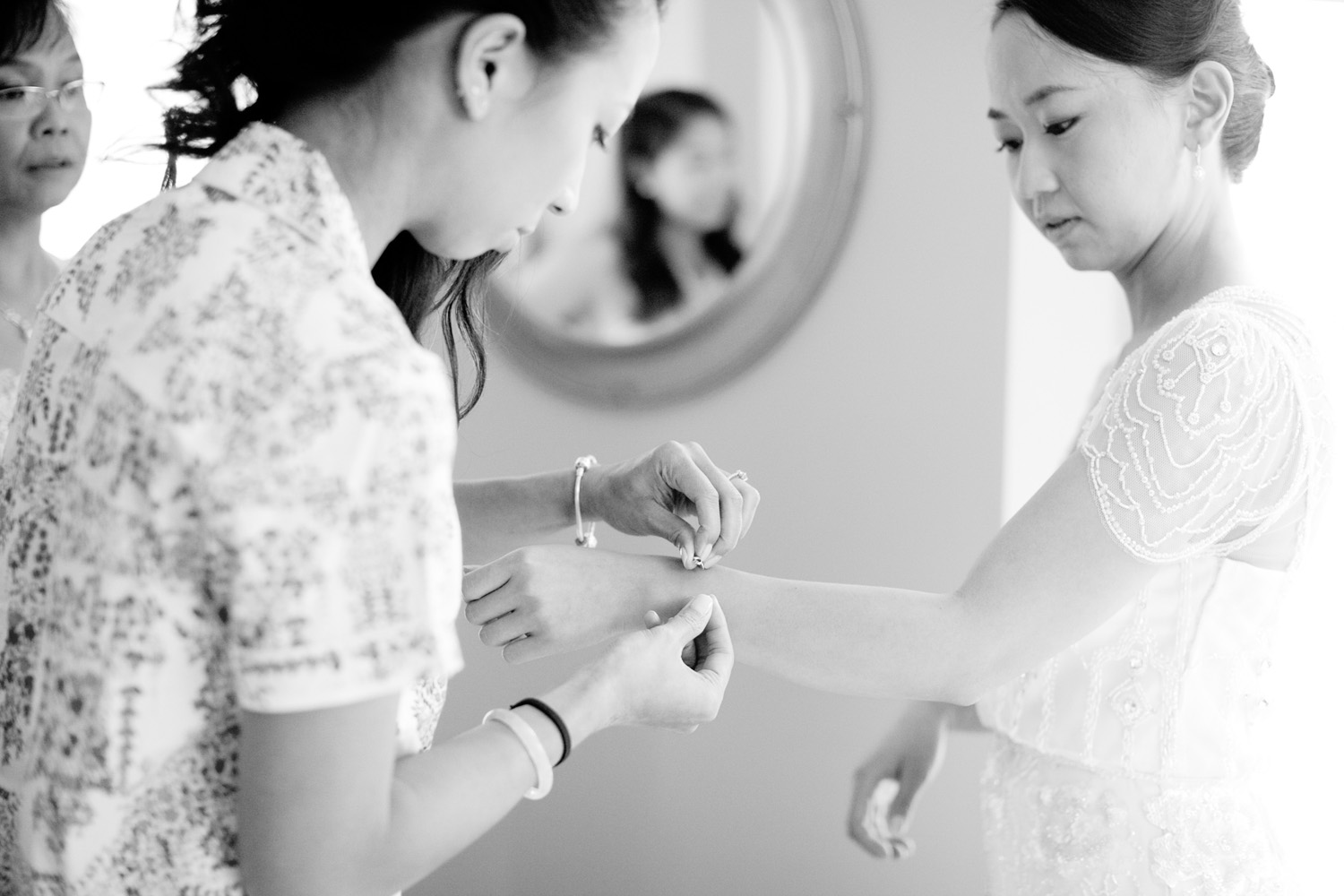 bride and bridesmaid getting ready