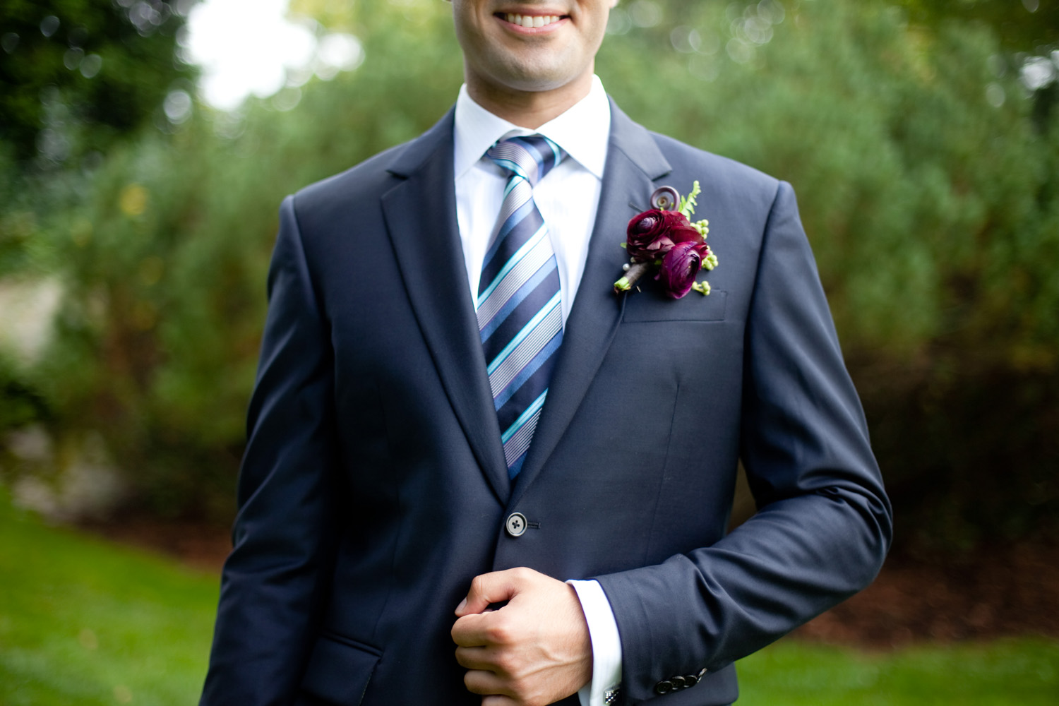 navy suit groom with burgundy boutonniere